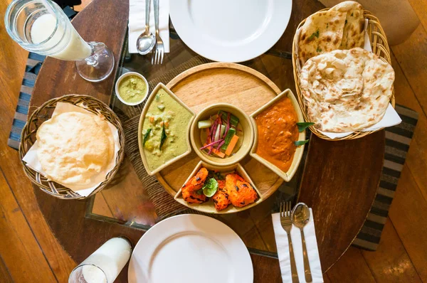 Top view of served Indian cuisine dishes in bowls and white plat — Stock Photo, Image