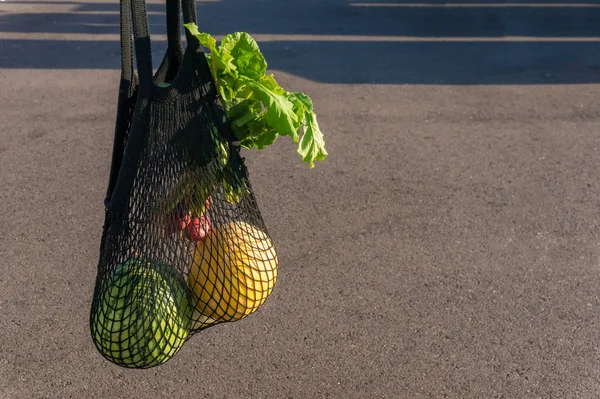 Fresh farmers produce in black mesh string bag — 스톡 사진