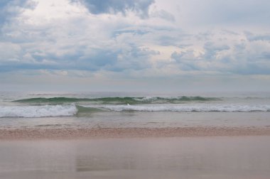 Stormy weather ocean landscape with overcast sky and mild waves