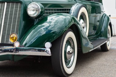 Shiny green vintage car front and wheels