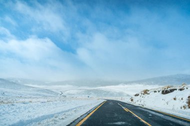 Winter landscape with ice covered asphalt road