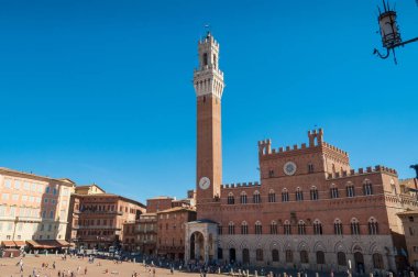 Piazza del Campo with tower and crowds of people