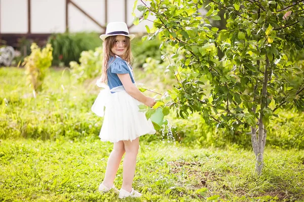 La petite fille avec l'arrosoir dans le jardin — Photo