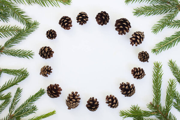 flat lay chrismas round frame with fir branches and pine cones