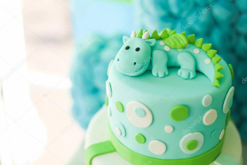 Blue and green birthday cake with cute dragon