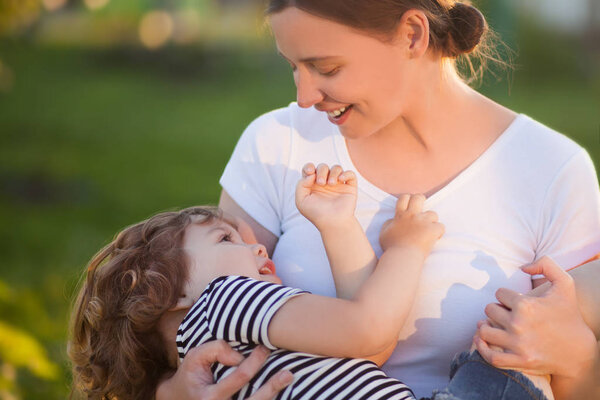 Cute toodler girl on her mothers hands