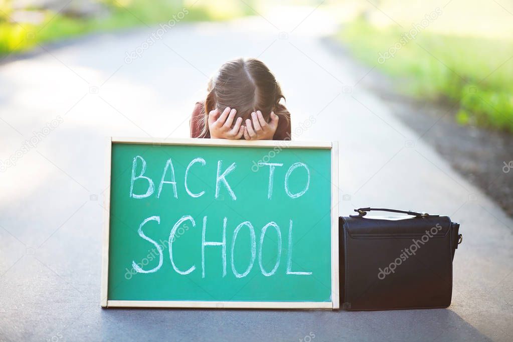 Little girl frightened and unhappy back to school