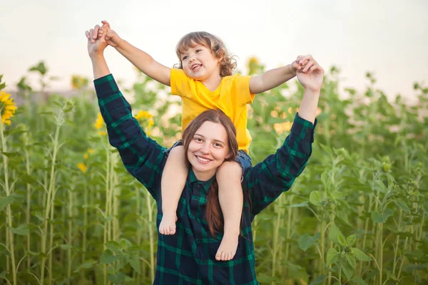 Happy mother and child together, family farm, sunflower field — Stock Photo, Image