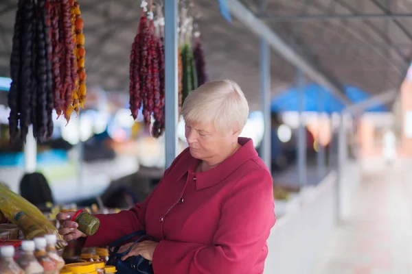 Vrouw op de markt, het kiezen van exotische specerijen en kruiden Stockafbeelding