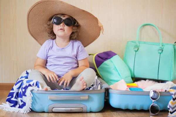 Little kid sitting inside a suitcase, ready for a big journey — Stock Photo, Image