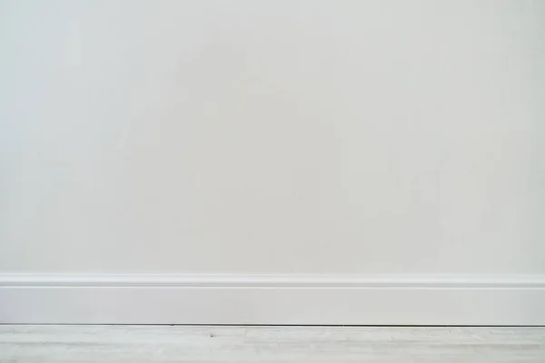 Empty room with white cement wall texture and white wooden floor pattern. — Stock Photo, Image
