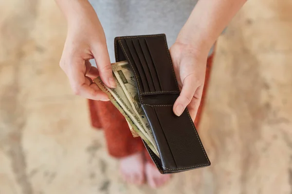 Indian rupees in a wallet. The wallet in the hands of a girl with Indian rupees