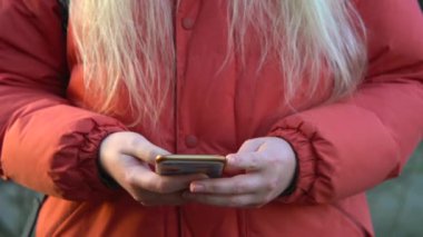 Overhead hacker in the hood working with laptop typing text in the darkroom. 
