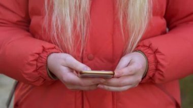 Girl browses social networks on her own phone.