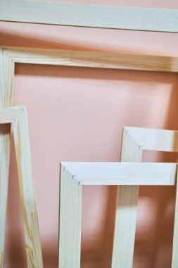Wooden frames on a pink background. Frames for photos and paintings
