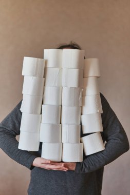 Bir kız bir sürü tuvalet kağıdı tutar. Koronavirüs sırasında karantina. 