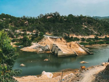 The destroyed bridge over the mountain river. Concrete bridge collapsed after the flood. Fallen bridge piers. A river in the mountains. Element. End of the road