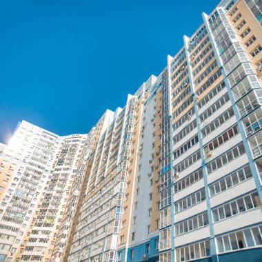 Modern bir gökdelenin güzel manzarası ve manzarası ve yüksek bir bina, balkonları ve loggiaları olan, camdan ve betondan yapılmış bir bina..