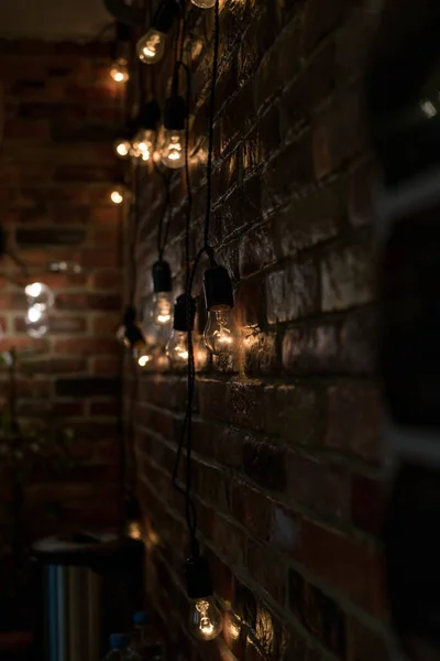 Texture Brick Wall Garland Glowing Incandescent Light Bulbs Warm Color — Stock Photo, Image