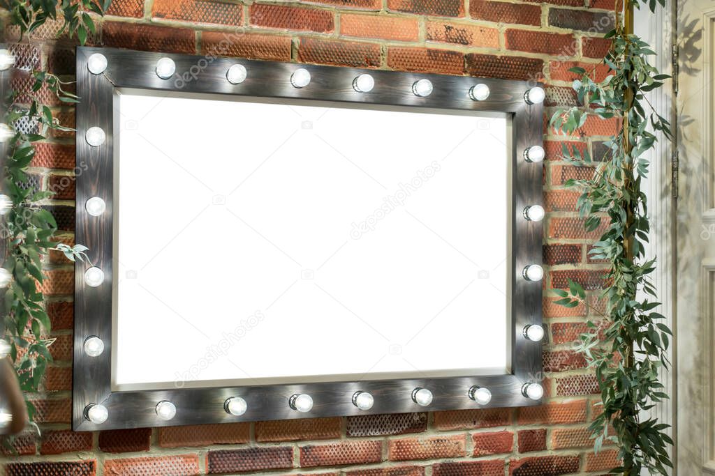 A banner, a sign, an empty place to fill with information made from a frame with light bulbs around the perimeter of the frame, as for makeup artists.