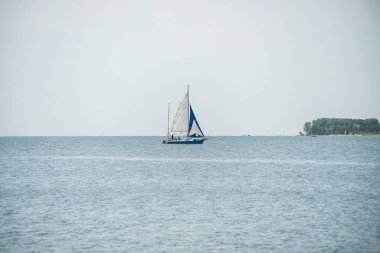Güzel ve görkemli deniz manzarası ve okyanus manzarası. Uzakta ıssız bir yat..