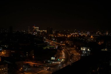 Novosibirsk, Rusya - 24 Mart 2020. Gece manzarası ve manzarası güzel. Büyük şehir ve başkent, aydınlık, karanlık gökyüzü ve fener ve pencerelerden gelen ışık..