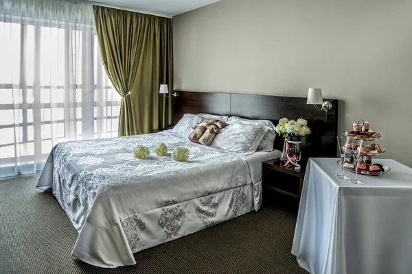 Beautiful, expensive, fashionable view of the wedding room with warm lighting, a room in the interior of a hotel room.