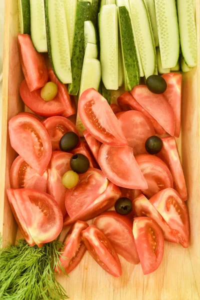 A beautiful and tasty fresh and environmentally friendly dish of vegetables, tomatoes and cucumbers.