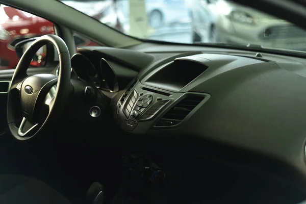 Beautiful control panel and dashboard with a steering wheel in a black car, expensive, stylish, dark and black.