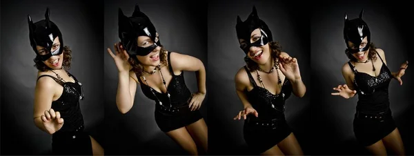 穿着深色衣服 戴着黑色面具的猫 站在漆黑的背景上的学院 蒙太奇 喜怒无常的美丽姑娘 图库图片