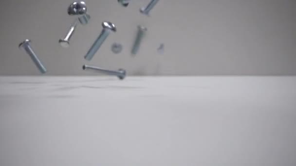 Bolts fall on the table. Slow Motion 250FPS. Close up. — Stock Video