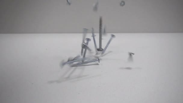 Tapping screw fall on the table. Close up. Slow Motion 250FPS. — Stock Video