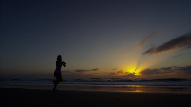 Woman on beach running for wellbeing — Stock video