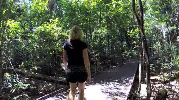 Woman walking on boardwalk — Stock Video