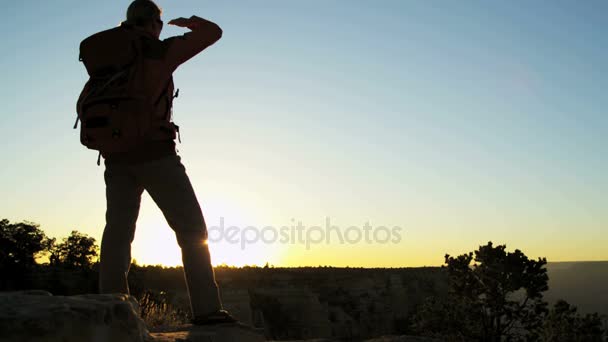 Female standing on the rocky edge — Stock Video