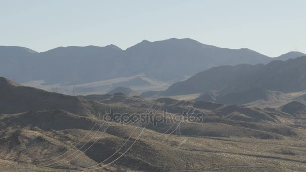 Electric cable Pylons across arid desert — Stock Video