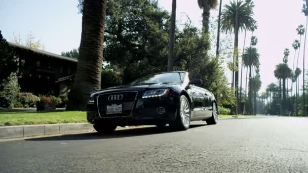 Open-top car cruising along street — Stock Video