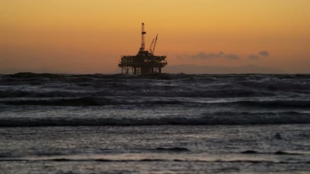 Oil rig coastal platform at sunset — Stock Video