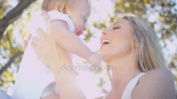 Mum holding her baby daughter outdoors — Stock Video