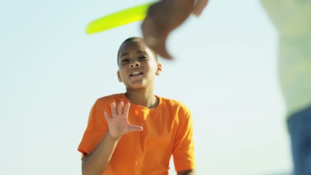 Hijo y padre divirtiéndose con un frisbee — Vídeos de Stock