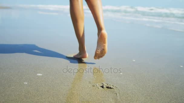 Female walking on wet sand — Stock Video