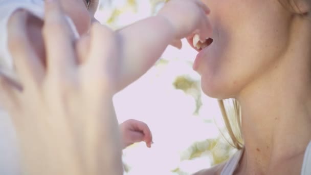 Mother holding her baby son outdoors — Stock Video