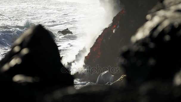 Lava flow beside jagged coastal rocks — Stock Video