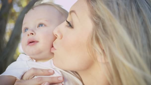 Mum giving her smiling baby boy a kiss — Stock Video