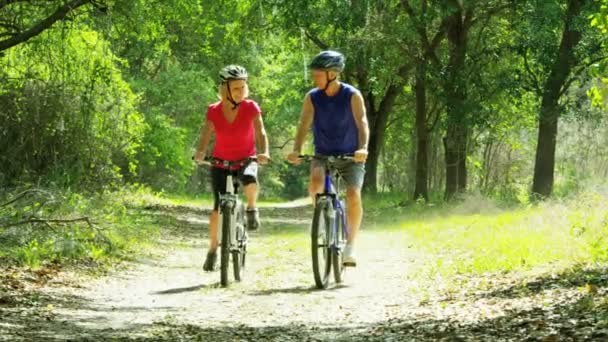 Pár, kteří požívají na kole v přírodě — Stock video