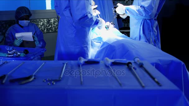 Training team in scrubs to perform a Laparoscopy operation — Stock Video