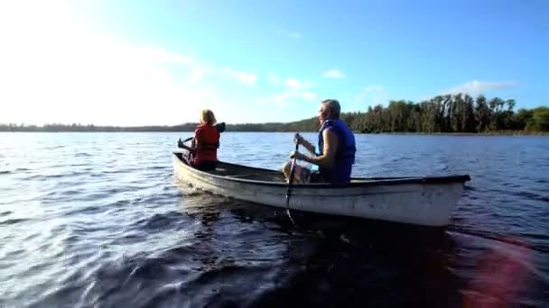 Пара в каноэ на озере — стоковое видео