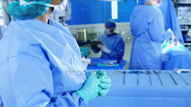 Female observing team in scrubs — Stock Video