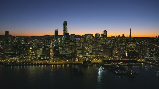 サンフランシスコ Salesforce ポートタワー高層ビル エンバカデロ ダウンタウン金融街ベイブリッジ カリフォルニアのサンフランシスコ 2017年 空中ウォーター フロント夜景 — ストック動画