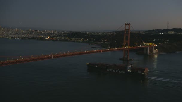 ゴールデン ゲート ブリッジ私たち 101 グローバル コンテナー船 サンフランシスコ市高層ビル米国カリフォルニア州のサンフランシスコ 2017年 空中照らされた夜ビュー — ストック動画